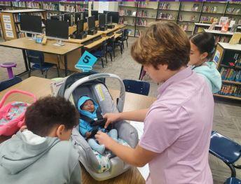 Family Consumer Science students practiced different skills required of caregivers of infants.  The students rotated through stations, read about skills, then had some hands on practice!